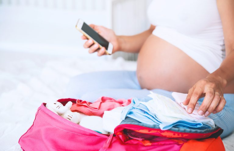 The Low-Key Gal’s Guide to Packing a Hospital Bag Pregnant mom packing hospital bag